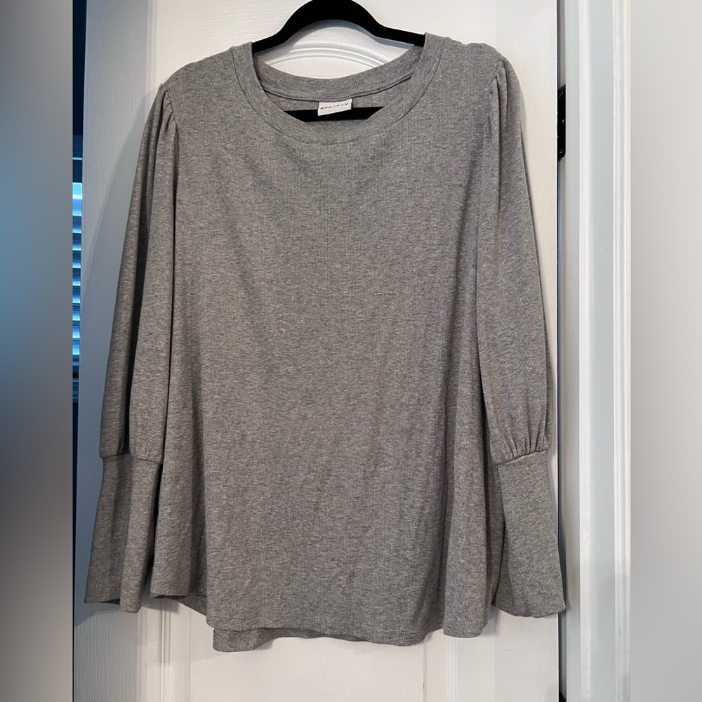 Grey sweater with fitted sleeve bottoms.